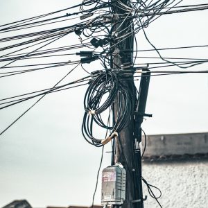 a bunch of wires and wires hanging from a pole